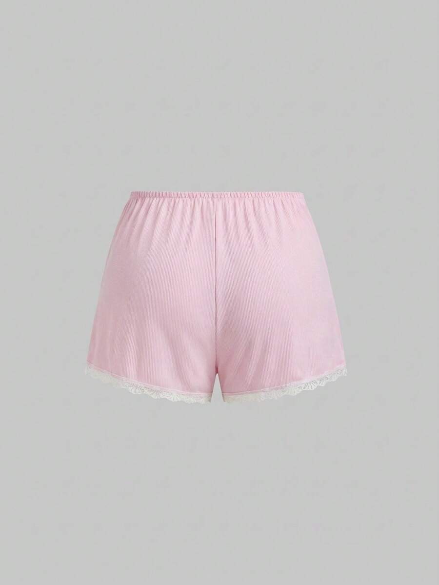 Two-piece ribbed pajama set featuring a lace-trimmed crop camisole top with spaghetti straps and matching shorts.