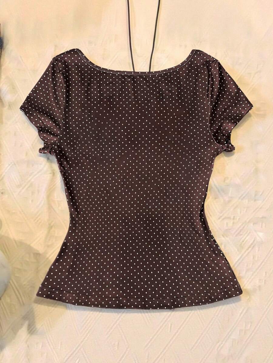 Women's polka dot short sleeve raglan t-shirt with a twist front detail and contrast collar.