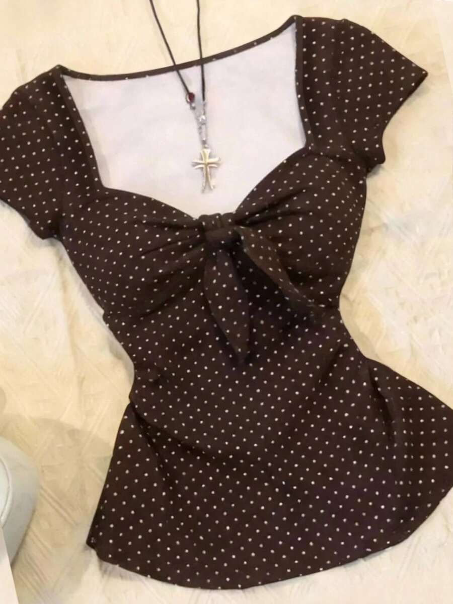 Women's polka dot short sleeve raglan t-shirt with a twist front detail and contrast collar.