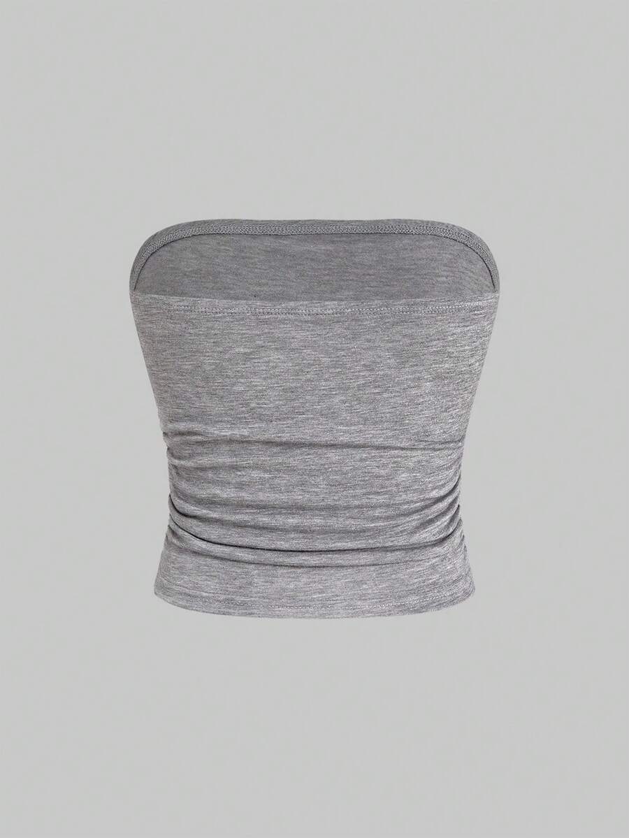 Women's strapless star-printed crop tube top with rhinestone and ruched details.