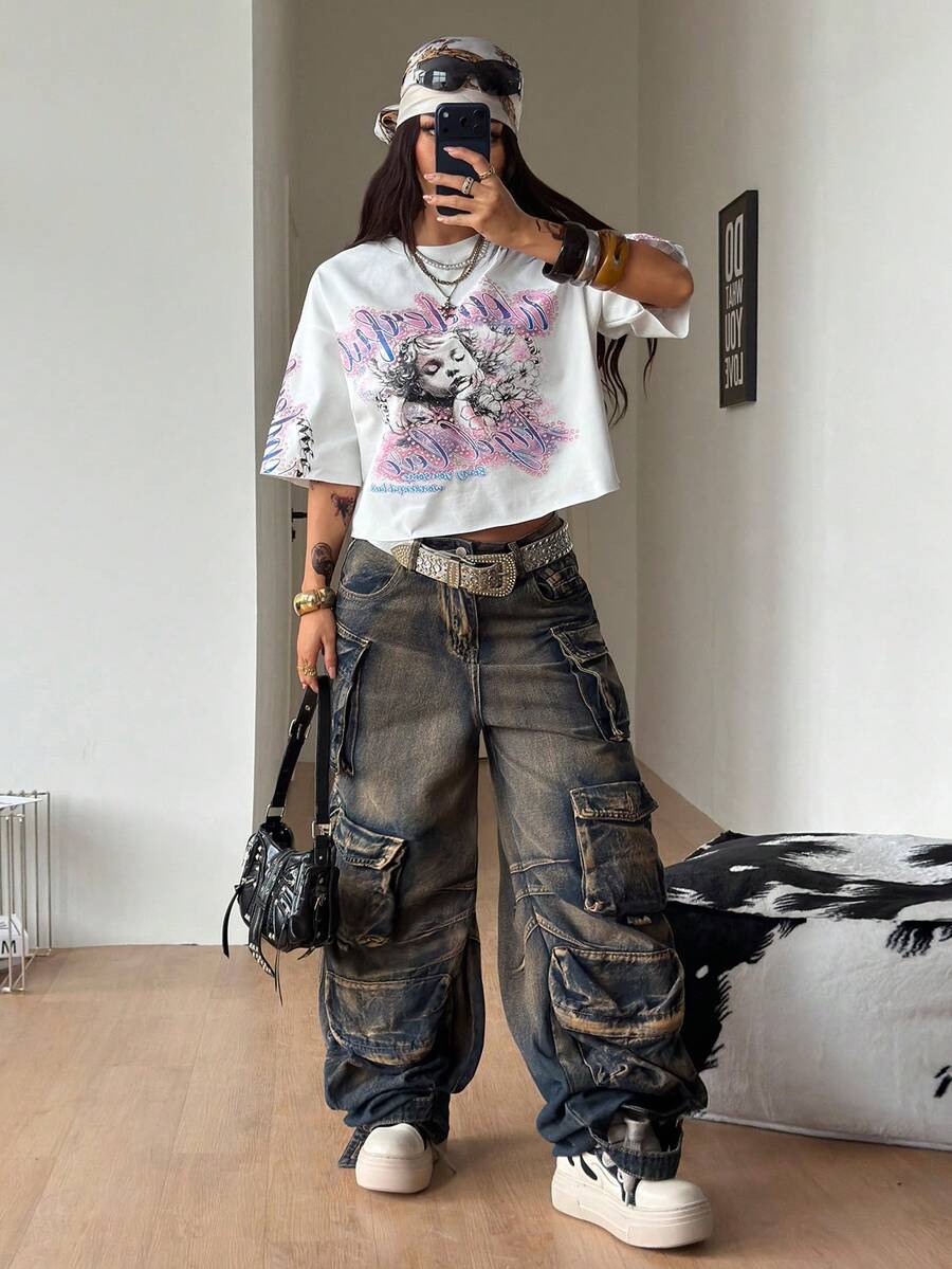 Front view of a women's black oversized crop t-shirt with pink lips graphic, round neckline, and short drop-shoulder sleeves.