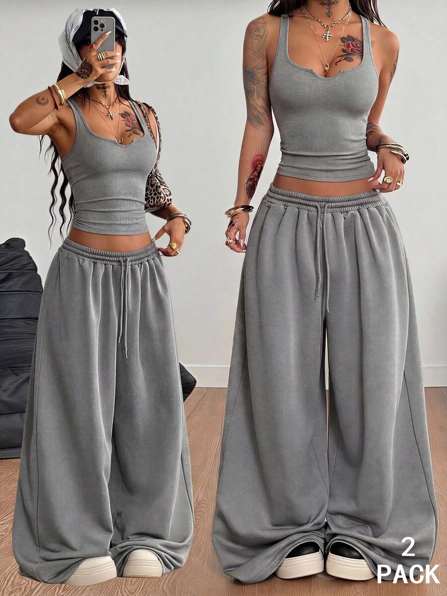 Women's two-piece casual outfit featuring a slim-fit camisole tank top with ruffle trim and button front paired with high-waisted wide leg pants.