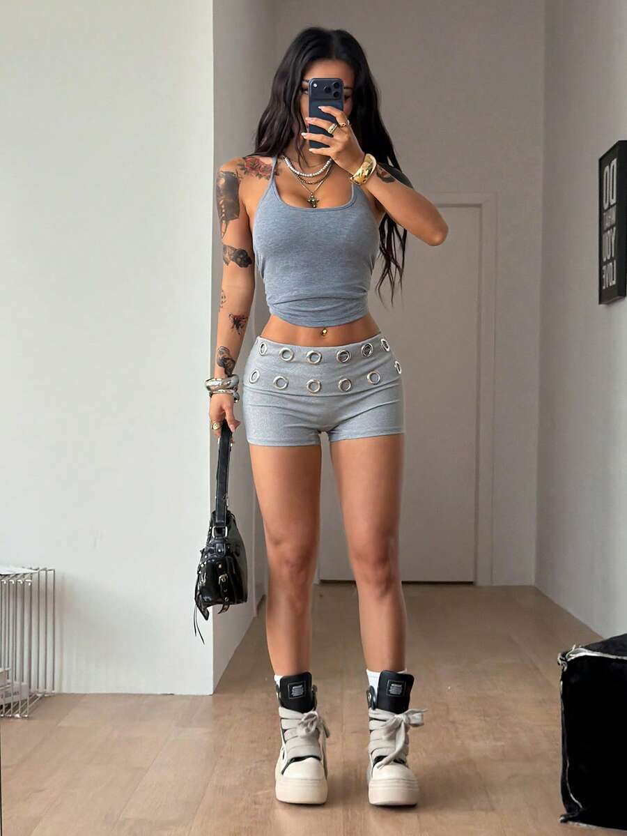 Women's light grey low waist track shorts with belted detail, zipper fly, and grommet eyelet accents