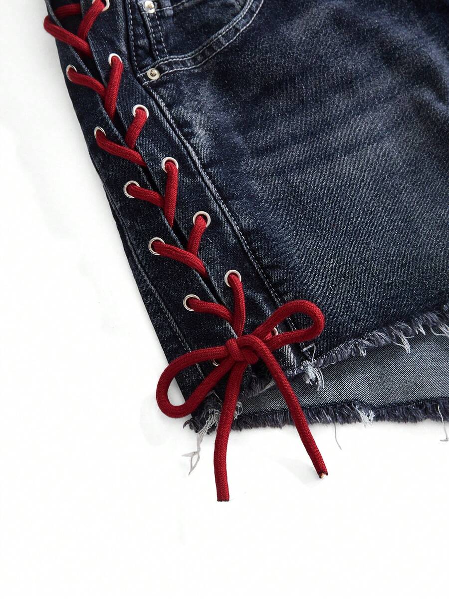 Plus size black gothic mini shorts with heart embroidery, graphic pocket pattern, lace-up detail, raw hem, and zipper fly