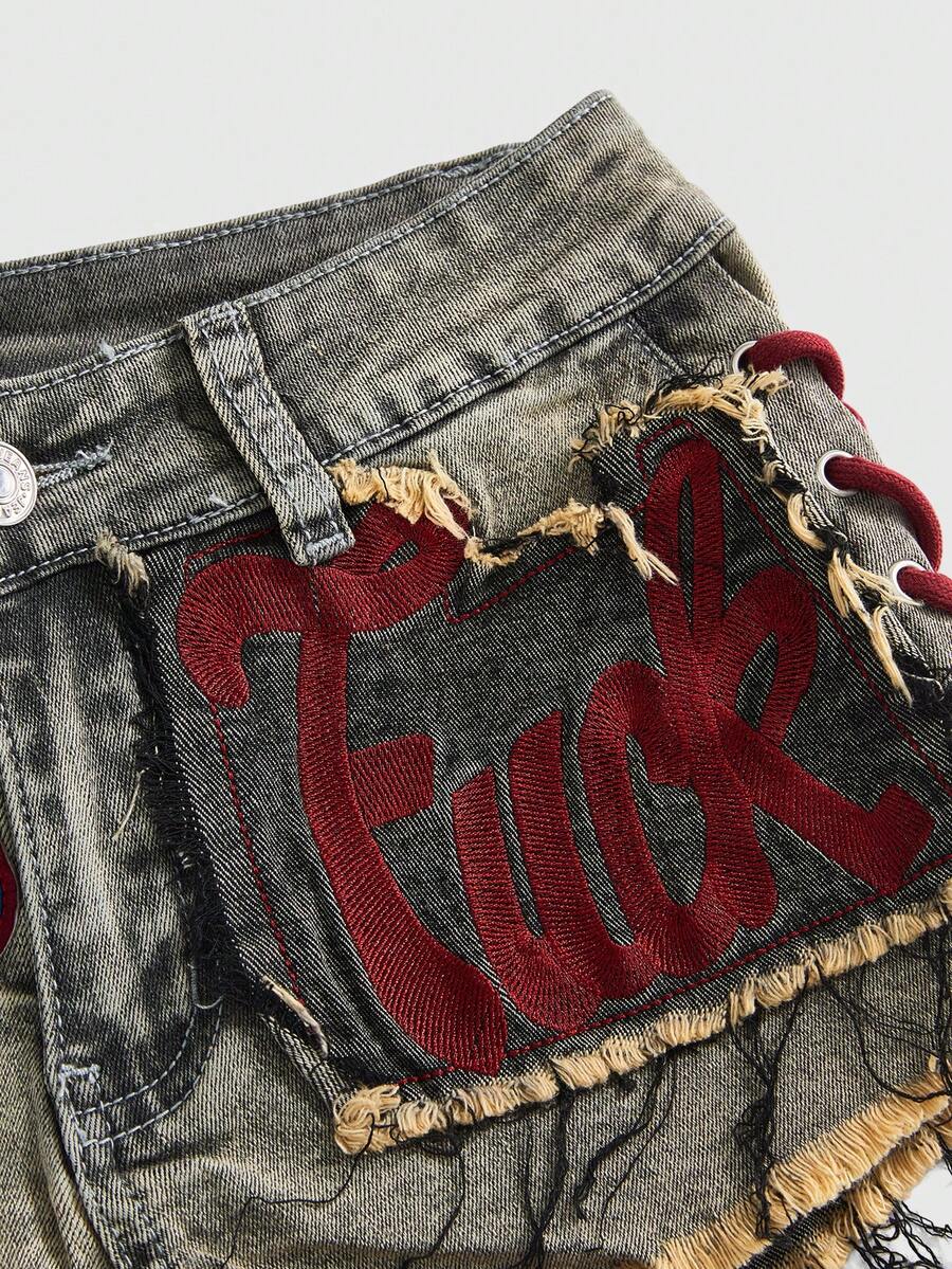 Women's Y2K low waist camo mini skort shorts featuring lace-up knot details, grommet eyelets, graphic lettering pattern, and a zipper fly.