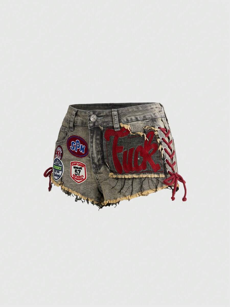 Women's Y2K low waist camo mini skort shorts featuring lace-up knot details, grommet eyelets, graphic lettering pattern, and a zipper fly.