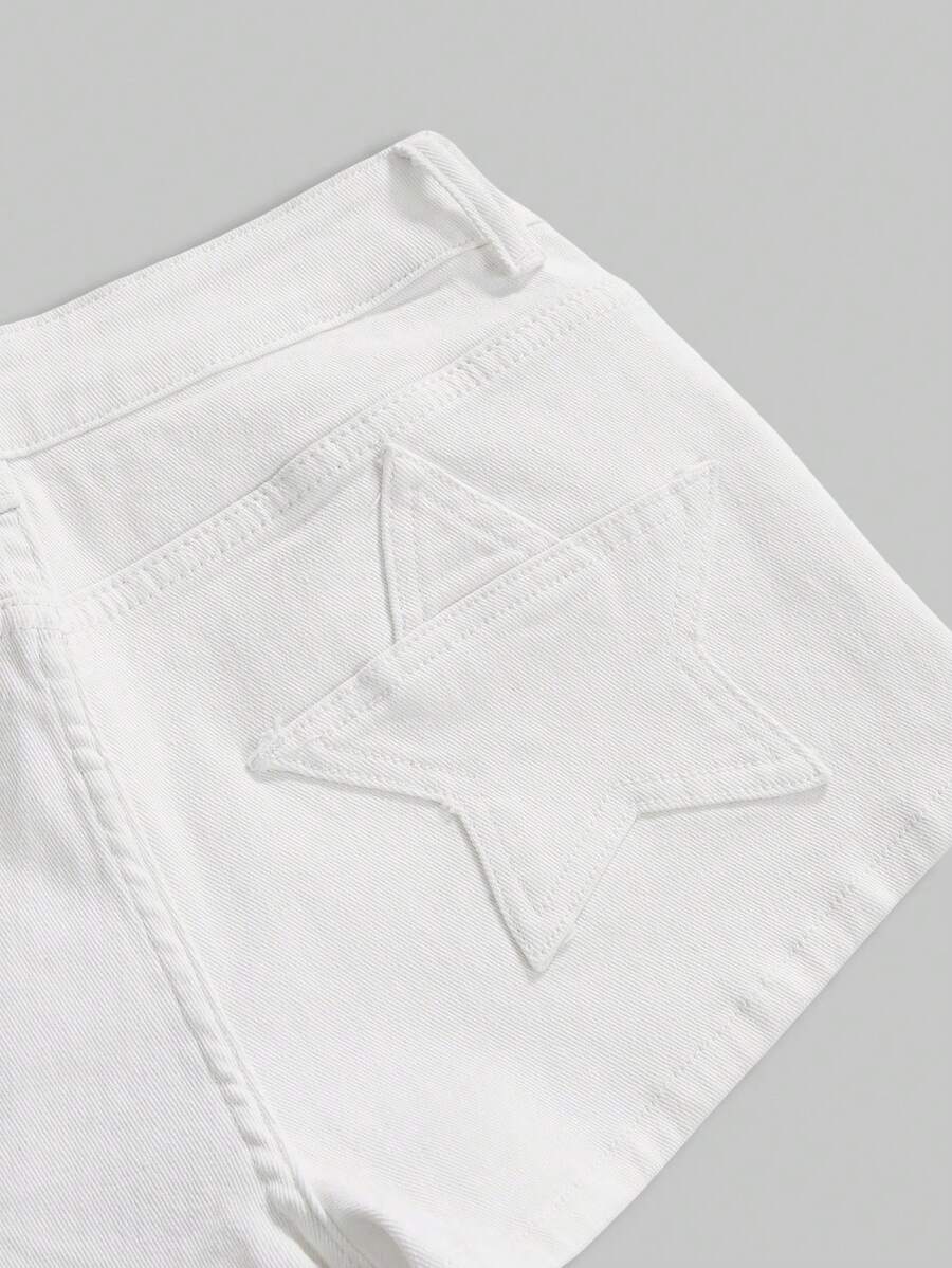 Women's ultra low waist mini shorts with back pockets, zipper fly, button detail, random print, and star patch in a grunge punk Y2K style.