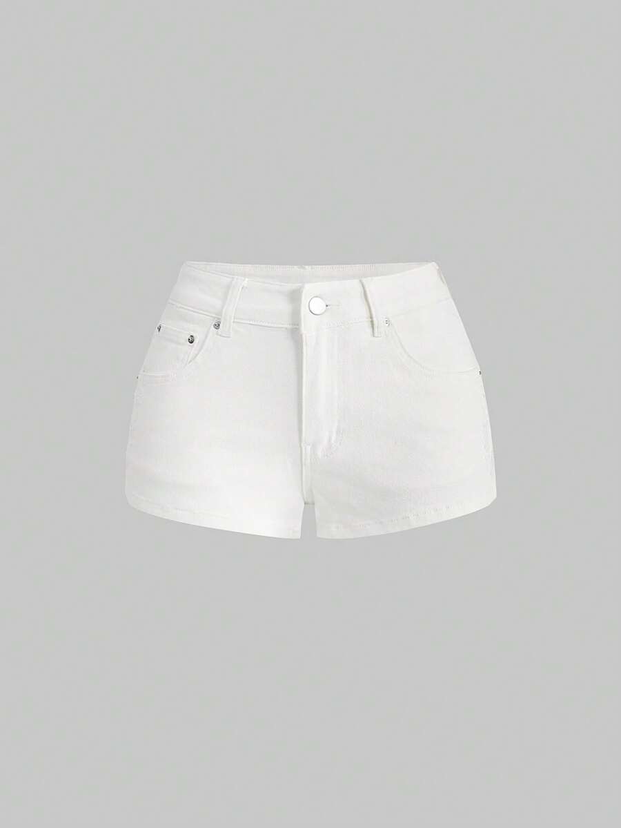 Women's ultra low waist mini shorts with back pockets, zipper fly, button detail, random print, and star patch in a grunge punk Y2K style.