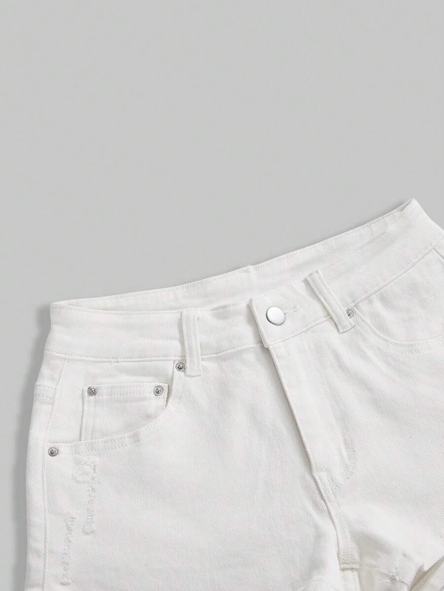 Women's ultra low waist mini shorts with back pockets, zipper fly, button detail, random print, and star patch in a grunge punk Y2K style.
