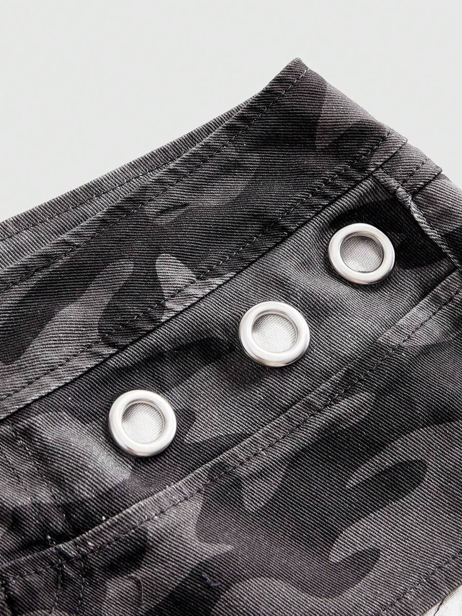 Women's ultra low waist camouflage mini skort shorts with zipper fly, button detail, and grommet eyelet accents.
