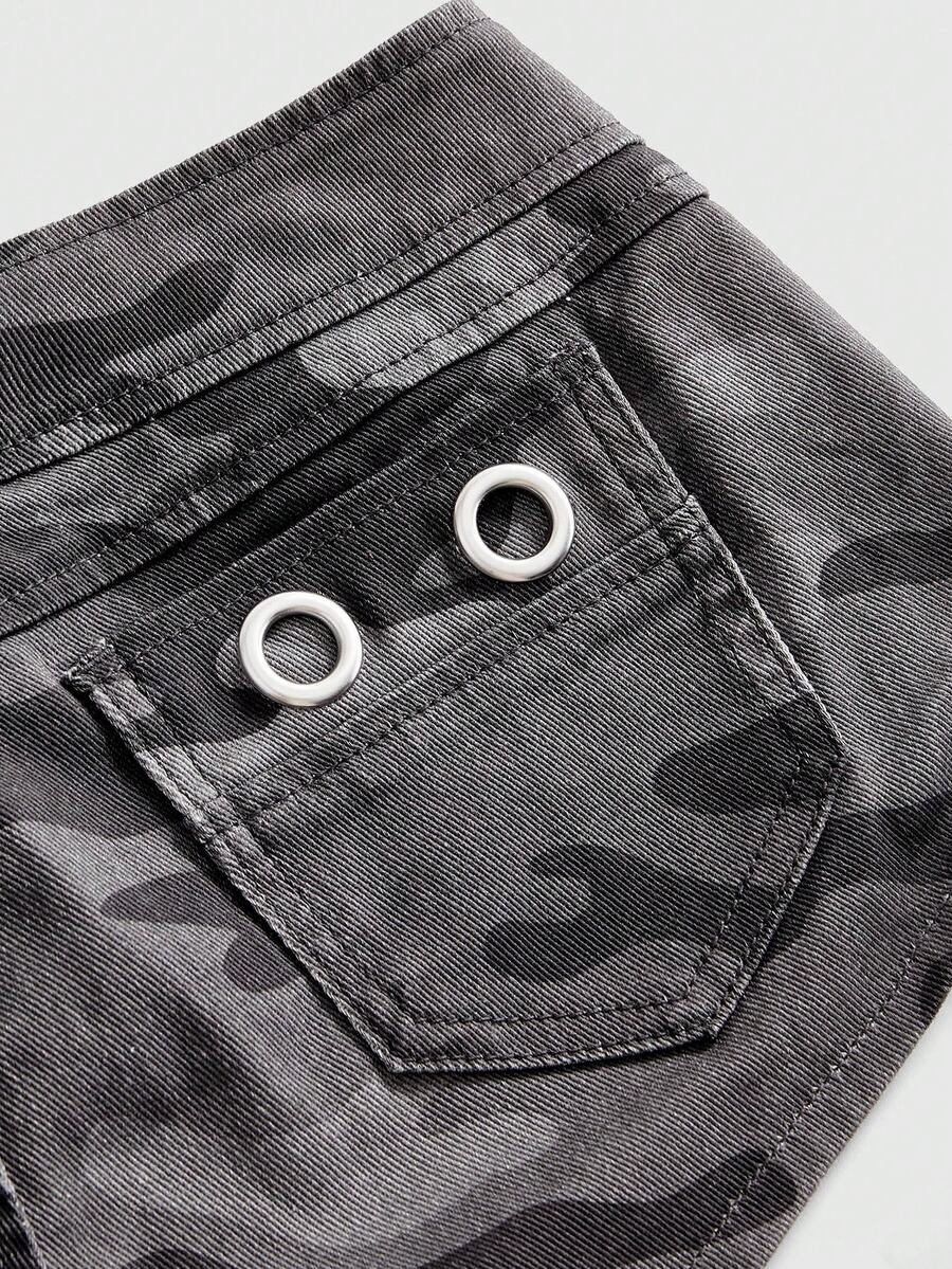 Women's ultra low waist camouflage mini skort shorts with zipper fly, button detail, and grommet eyelet accents.