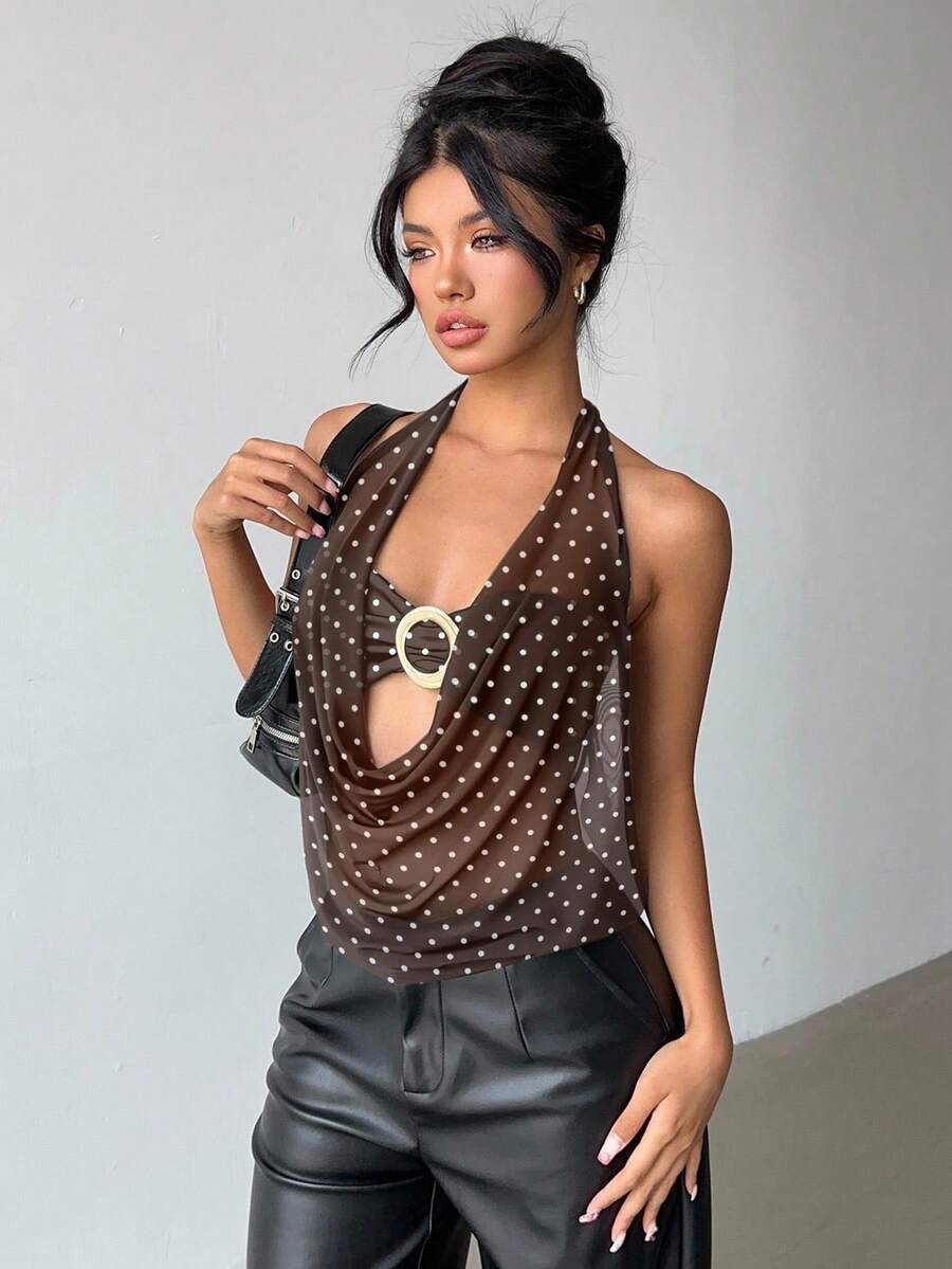 Brown and white polka dot semi-sheer halter camisole top with a plunging neckline, backless design, draped front, and metallic studded embellishments.