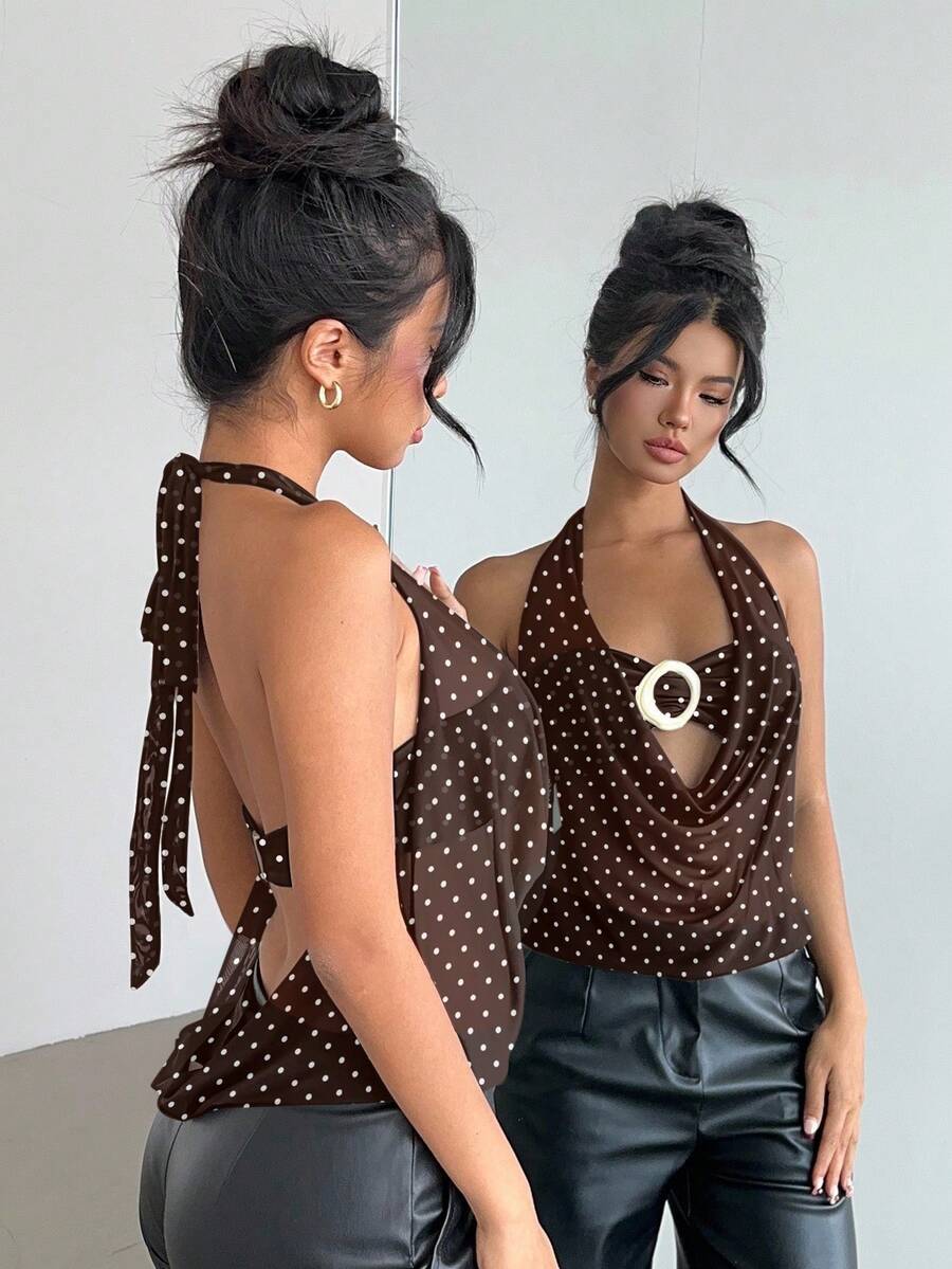 Brown and white polka dot semi-sheer halter camisole top with a plunging neckline, backless design, draped front, and metallic studded embellishments.