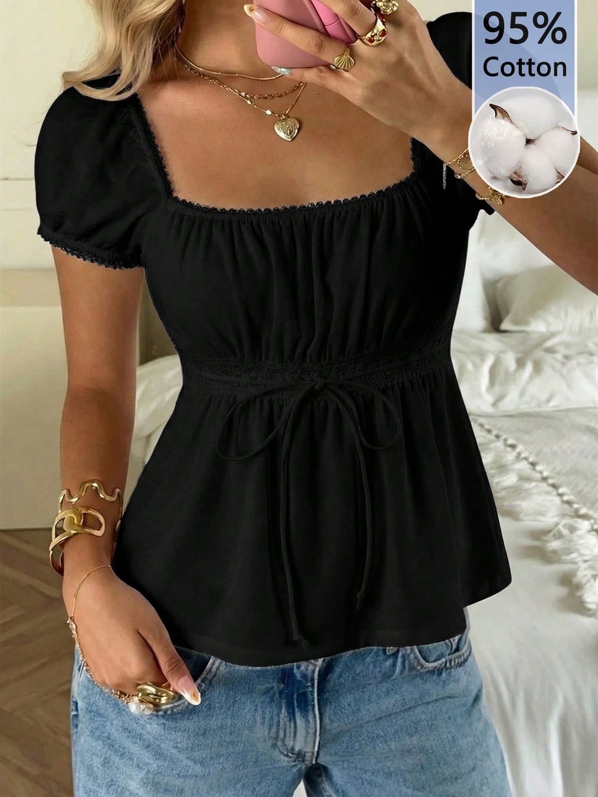 Women's black short puff sleeve top featuring a square neckline, ruched bust detail, and flared ruffle hem.