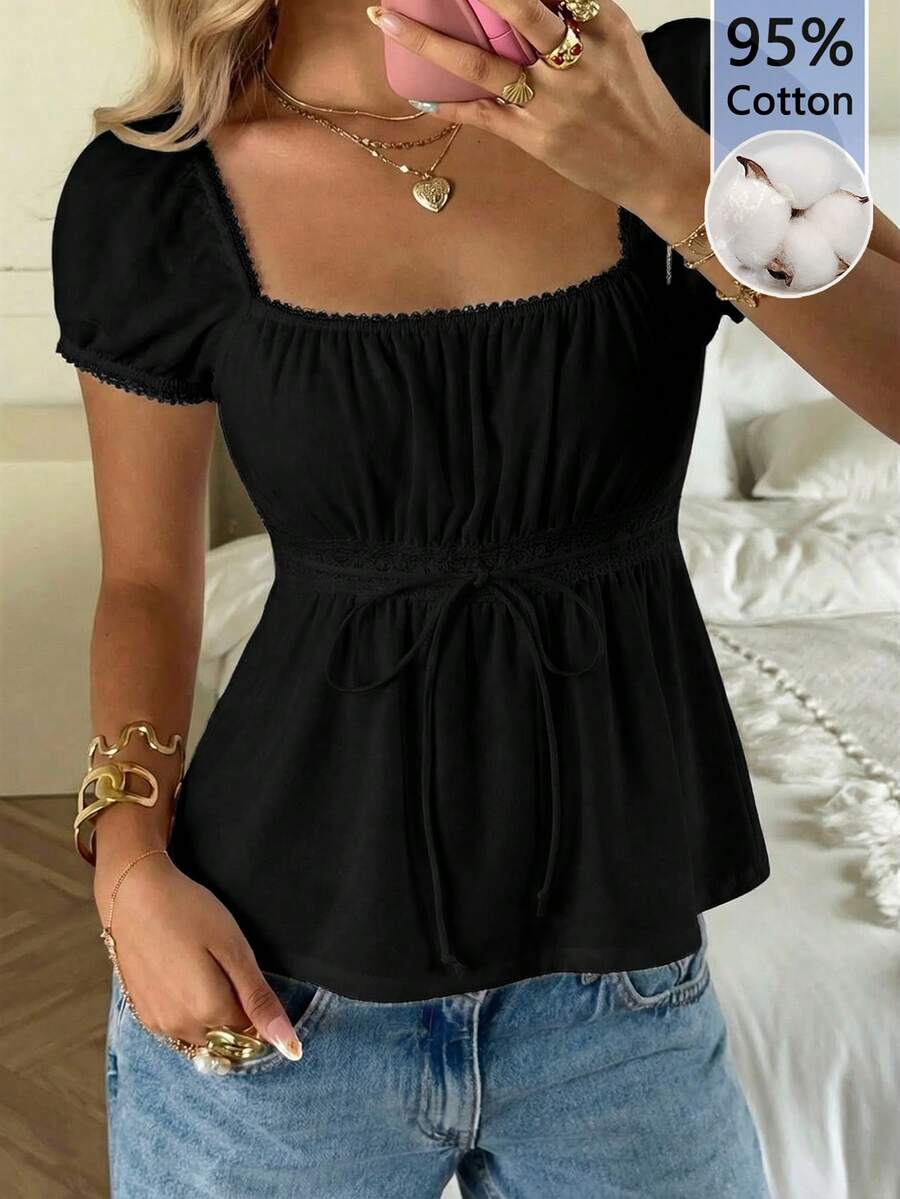 Women's black short puff sleeve top featuring a square neckline, ruched bust detail, and flared ruffle hem.