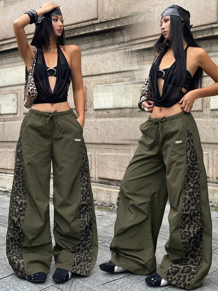 Women's black baggy jogger pants with an adjustable drawstring waist and colorblock polka dot geometric pattern.