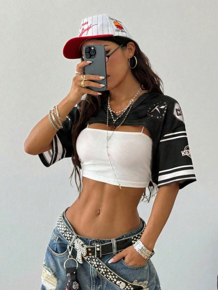 Front view of a women's black and white striped short sleeve crop top with a round neckline and semi-sheer knit finish.