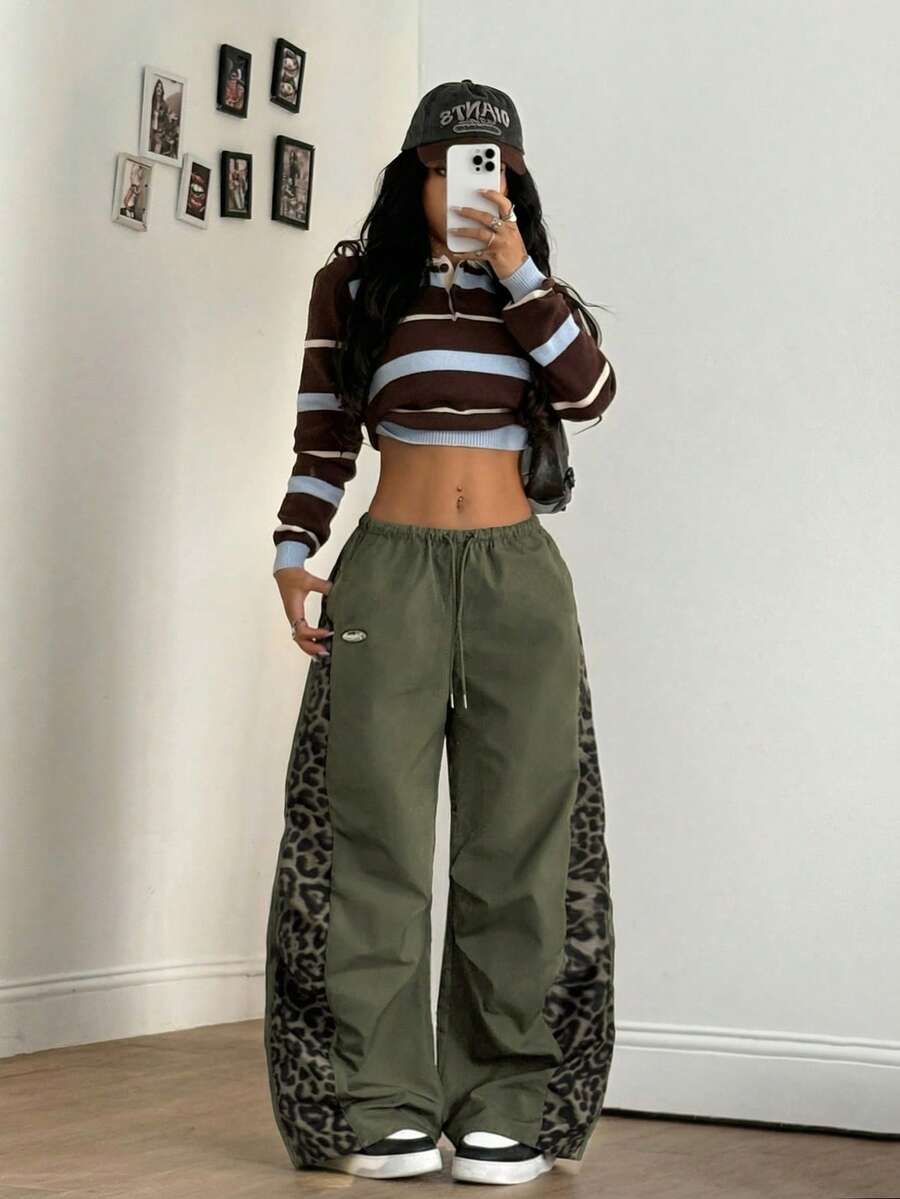 Women's black baggy jogger pants with an adjustable drawstring waist and colorblock polka dot geometric pattern.