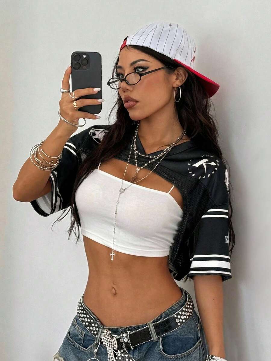 Front view of a women's black and white striped short sleeve crop top with a round neckline and semi-sheer knit finish.