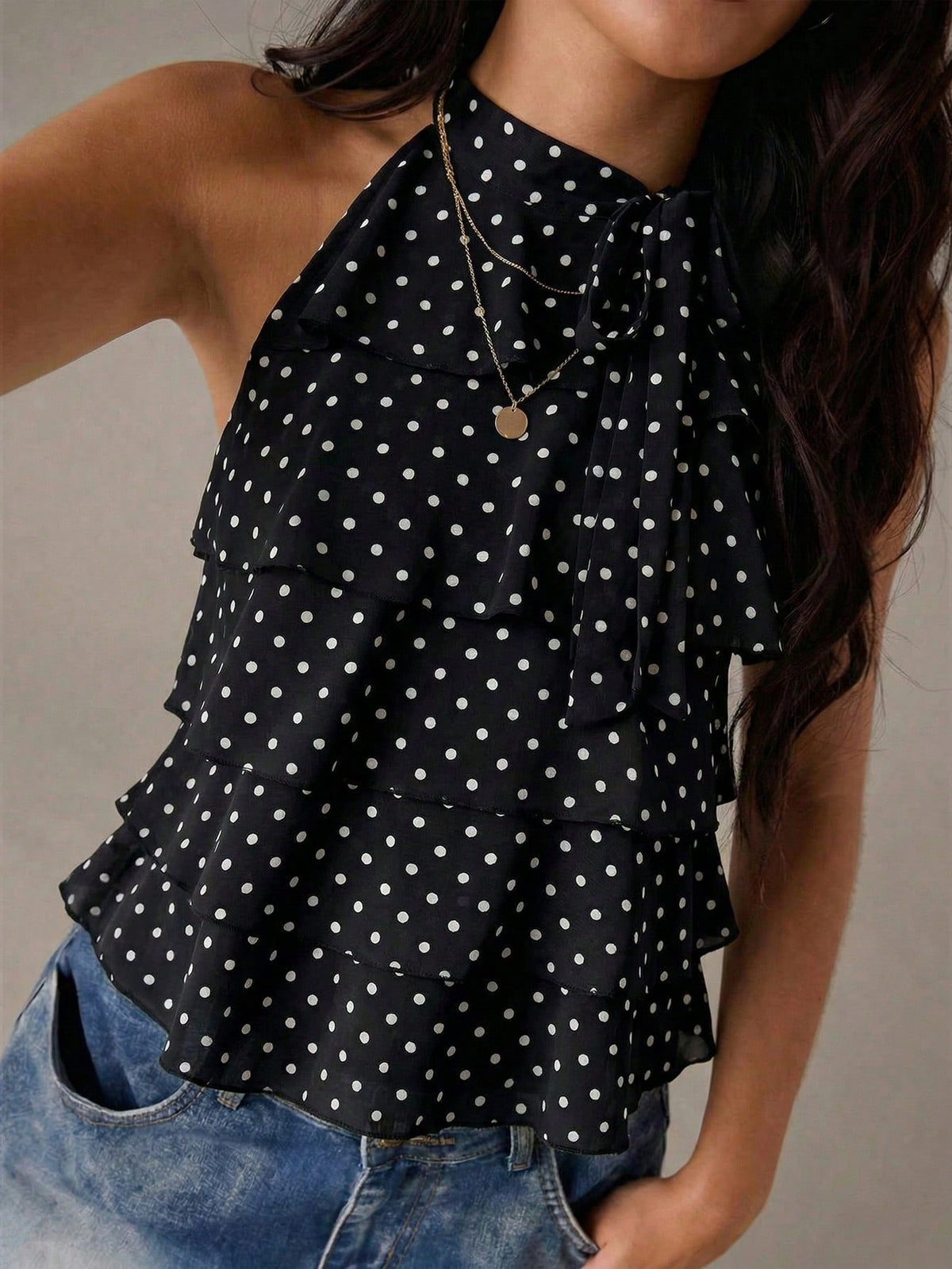 Women's sleeveless stand collar top in rib-knit fabric featuring button and hollow-out details.