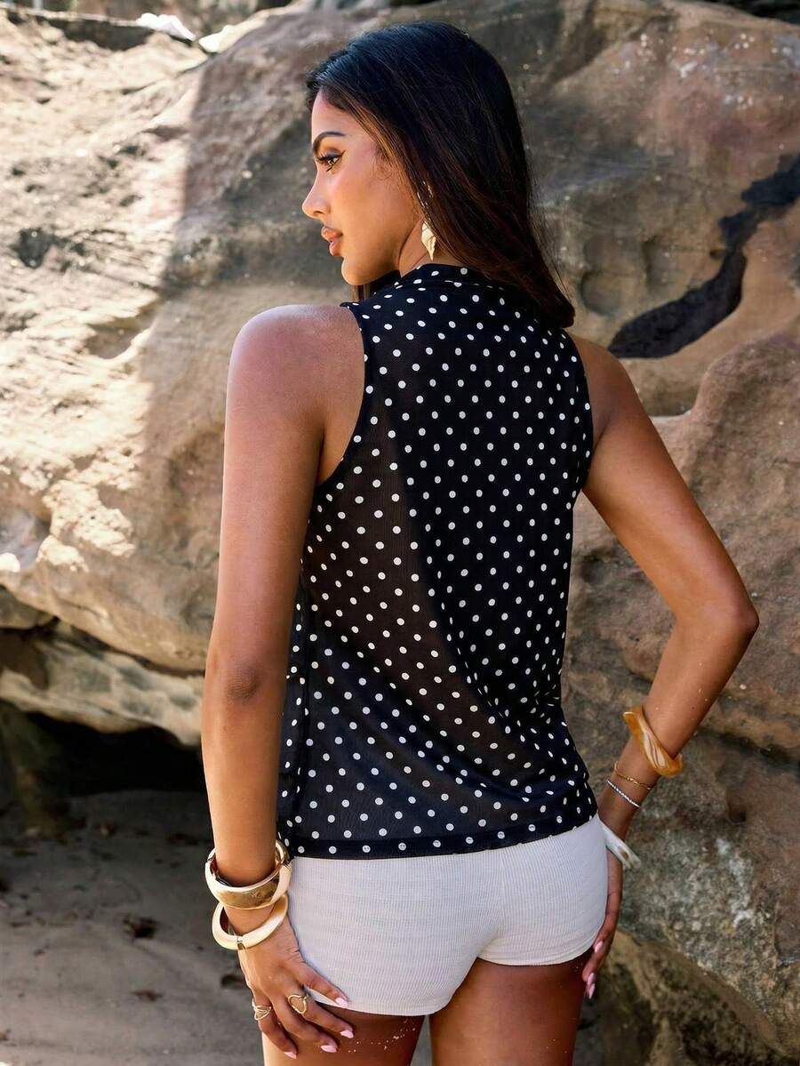 Women's sleeveless stand collar top in rib-knit fabric featuring button and hollow-out details.