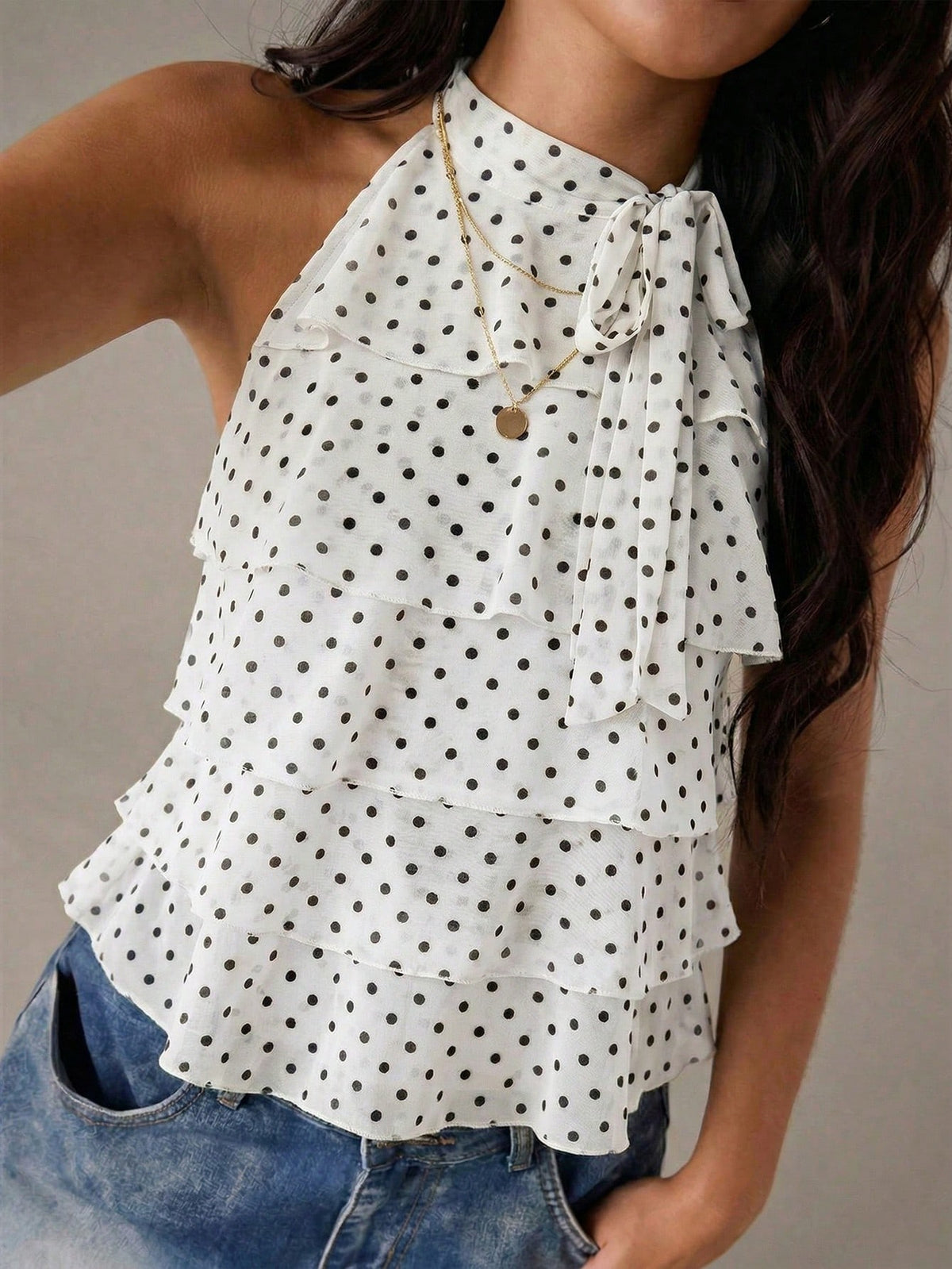 Women's sleeveless stand collar top in rib-knit fabric featuring button and hollow-out details.