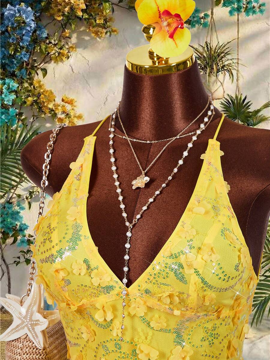 Women's embroidered sequin halter cami top featuring a deep V-neck, backless party design, and slim fit silhouette.