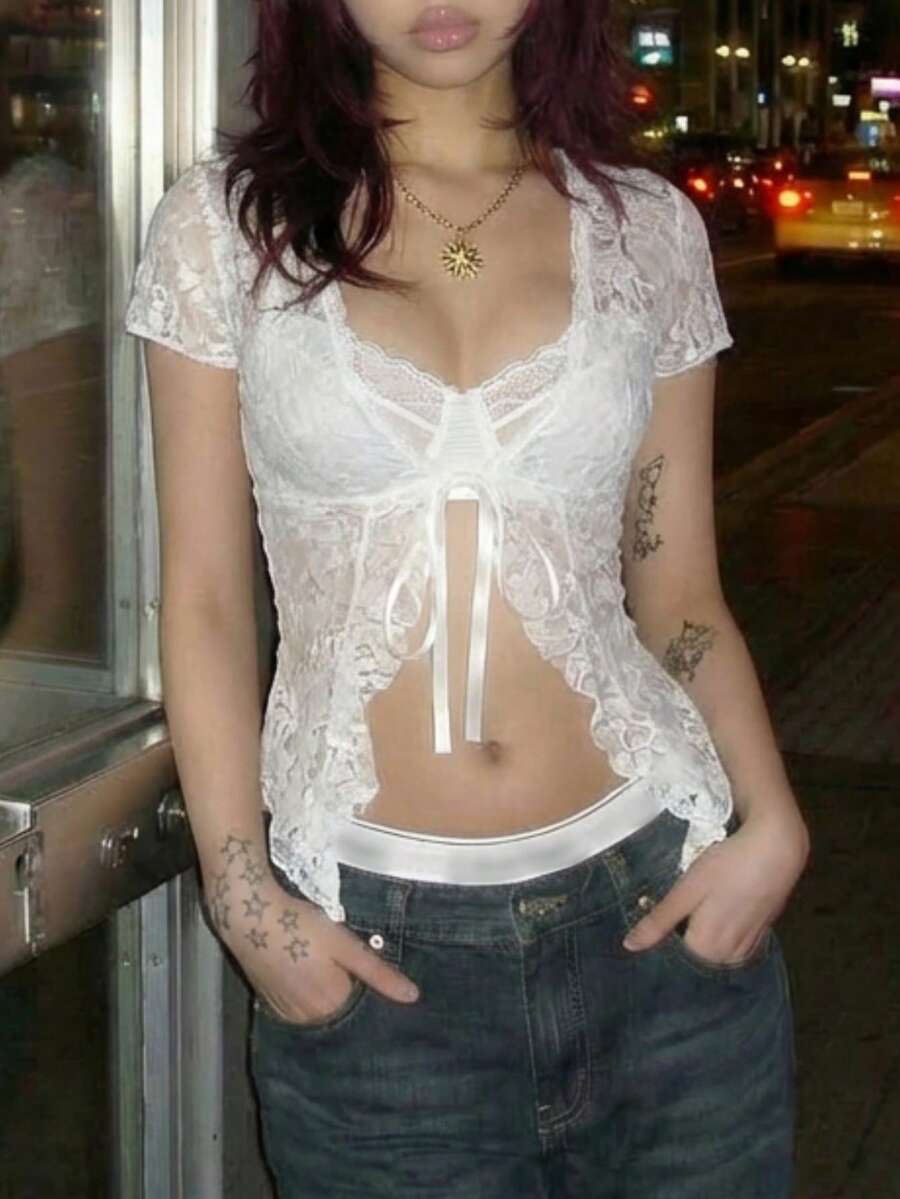 Women's semi-sheer deep V-neck top featuring cap sleeves, contrast lace trimming, and a lace-up front detail.
