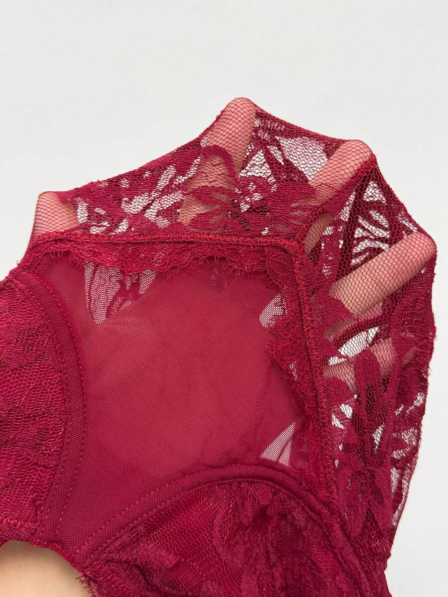 Fitted women's lace and mesh cami bodysuit with spaghetti straps.