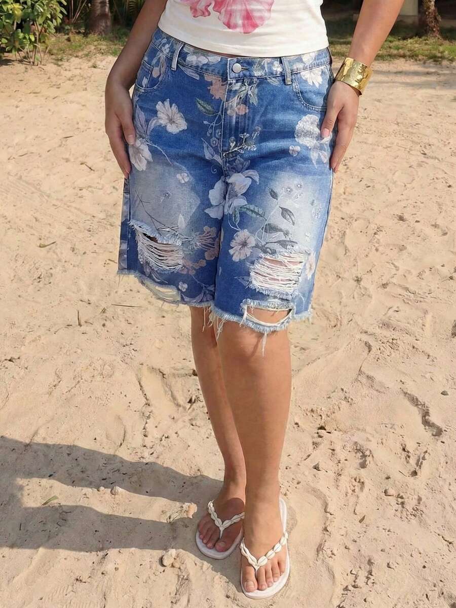 Women's loose wide-leg denim Bermuda shorts featuring vintage animal and paisley print with pockets and zipper fly.