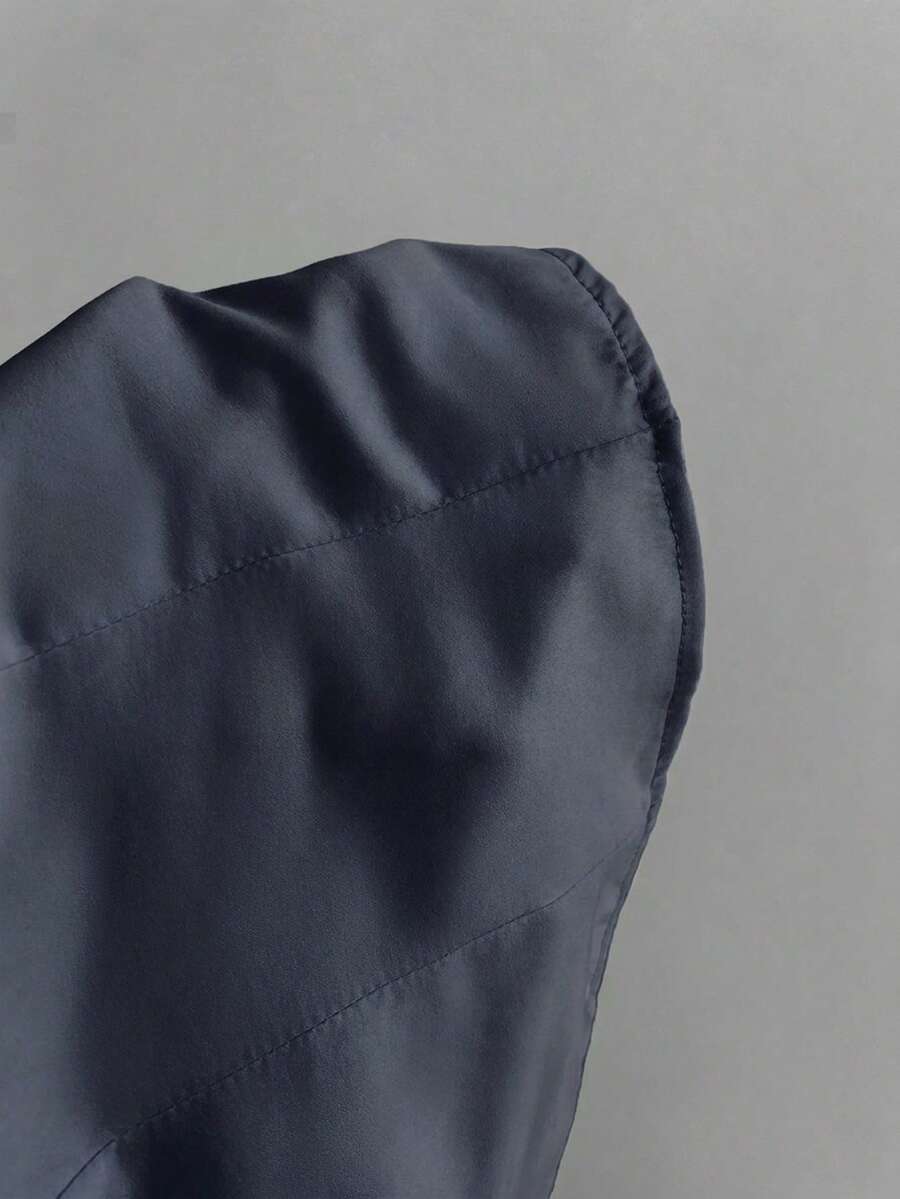 Women's black 2-in-1 blouse featuring a sweetheart neckline, short puff sleeves, front tie bow accent, and asymmetrical hem.