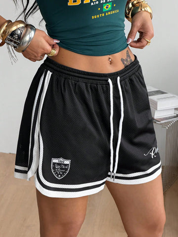 Women's black mesh track shorts featuring a drawstring waist, striped trim, and graphic letter print in a loose mini length.