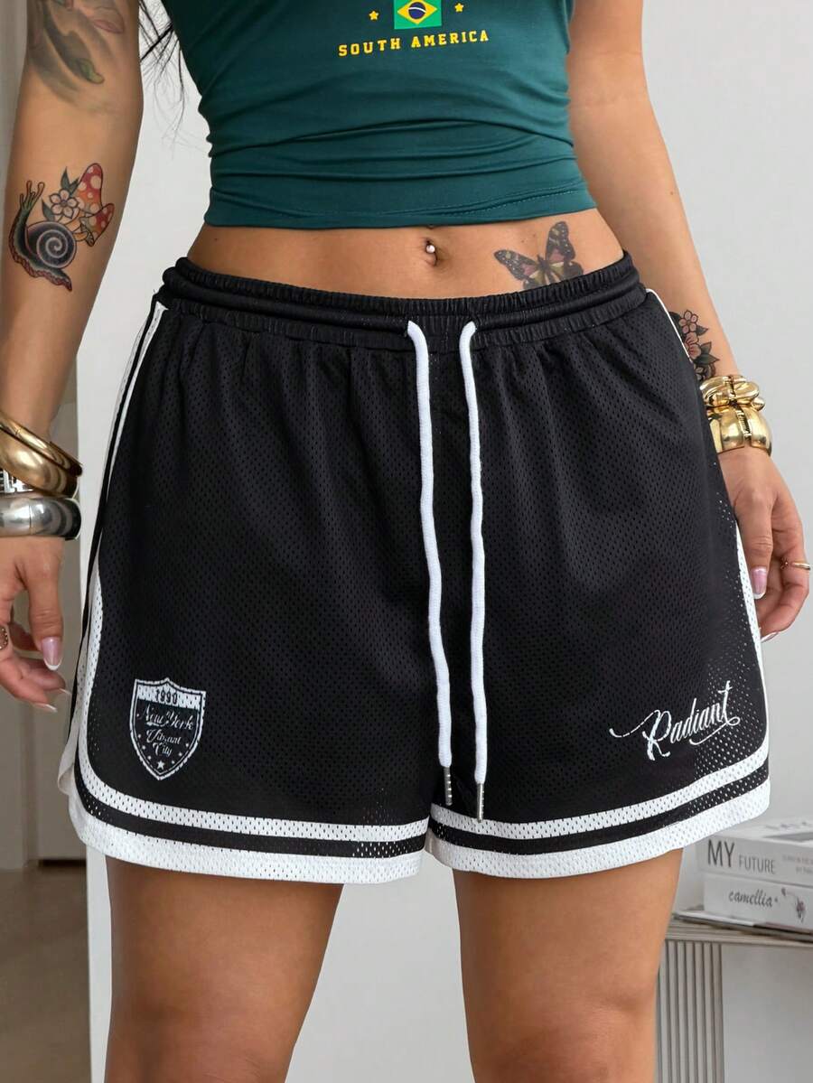 Women's black mesh track shorts featuring a drawstring waist, striped trim, and graphic letter print in a loose mini length.