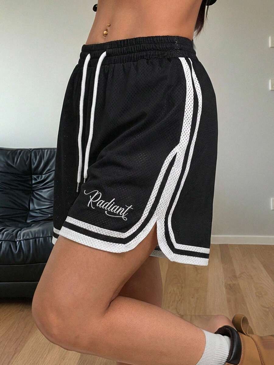 Women's black mesh track shorts featuring a drawstring waist, striped trim, and graphic letter print in a loose mini length.