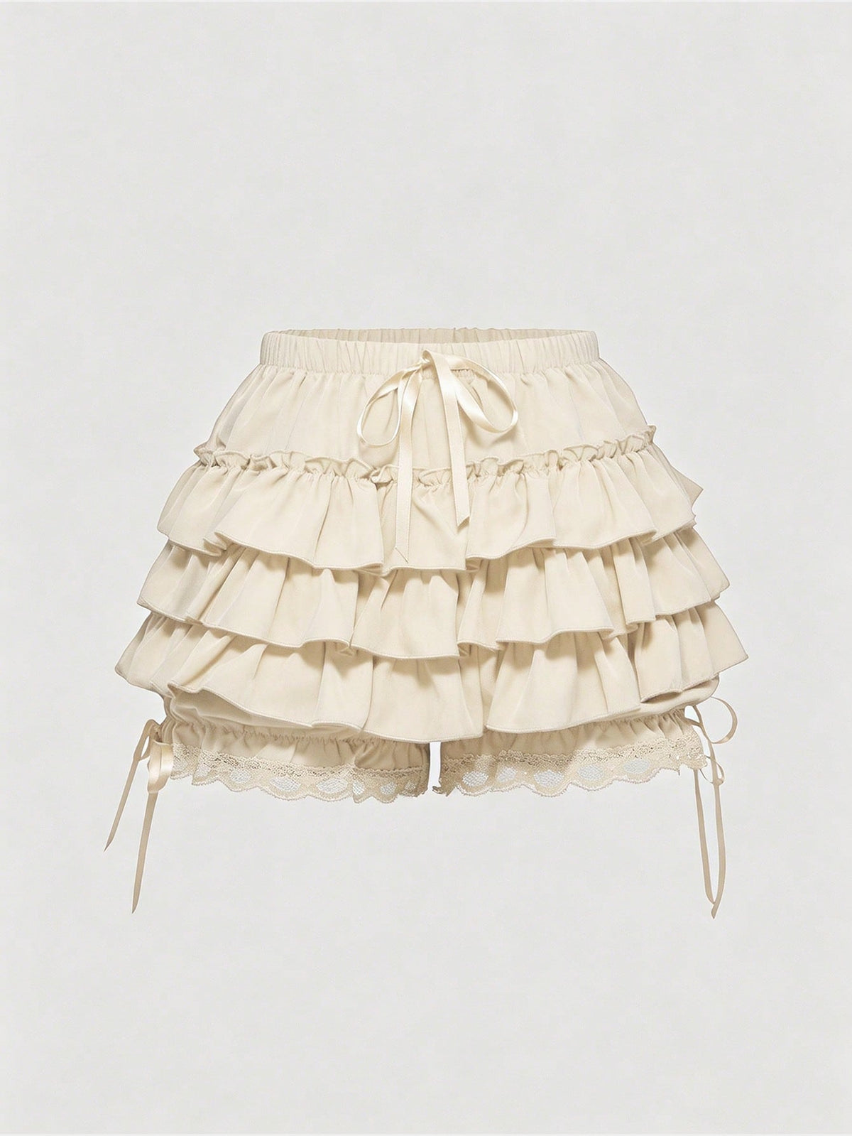 Women's tiered ruffle skort shorts featuring an elastic mid waist with front tie knot detail in woven fabric.