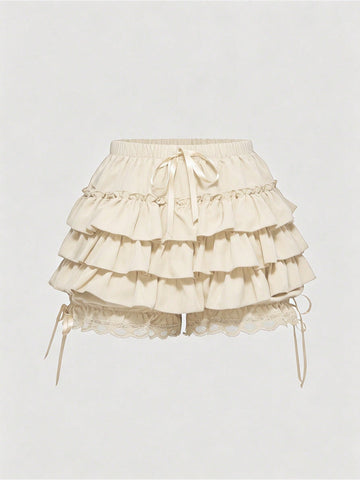 Women's tiered ruffle skort shorts featuring an elastic mid waist with front tie knot detail in woven fabric.