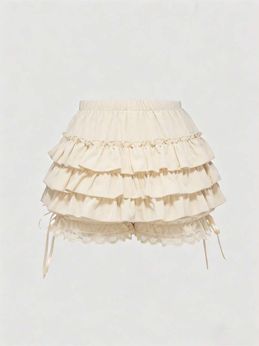 Women's tiered ruffle skort shorts featuring an elastic mid waist with front tie knot detail in woven fabric.