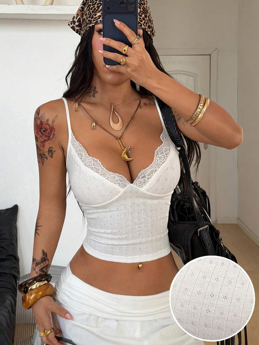 Slim fit cropped camisole top for women featuring contrast lace trim, ruched cup detailing, and delicate spaghetti straps.
