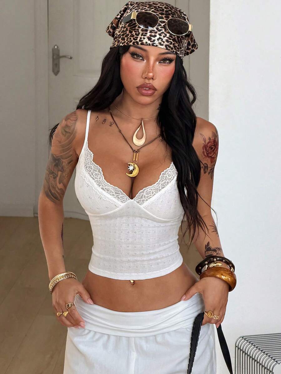 Slim fit cropped camisole top for women featuring contrast lace trim, ruched cup detailing, and delicate spaghetti straps.