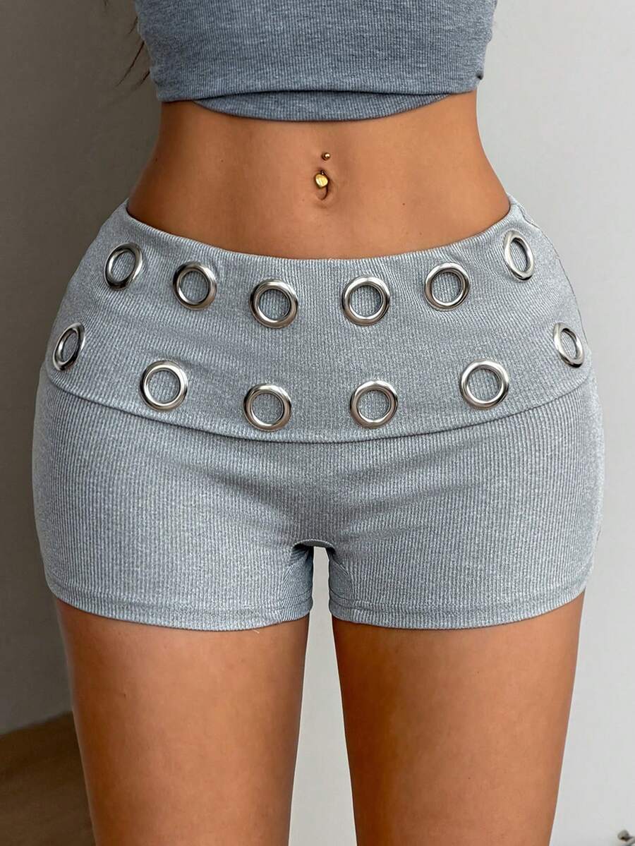 Women's light grey low waist track shorts with belted detail, zipper fly, and grommet eyelet accents