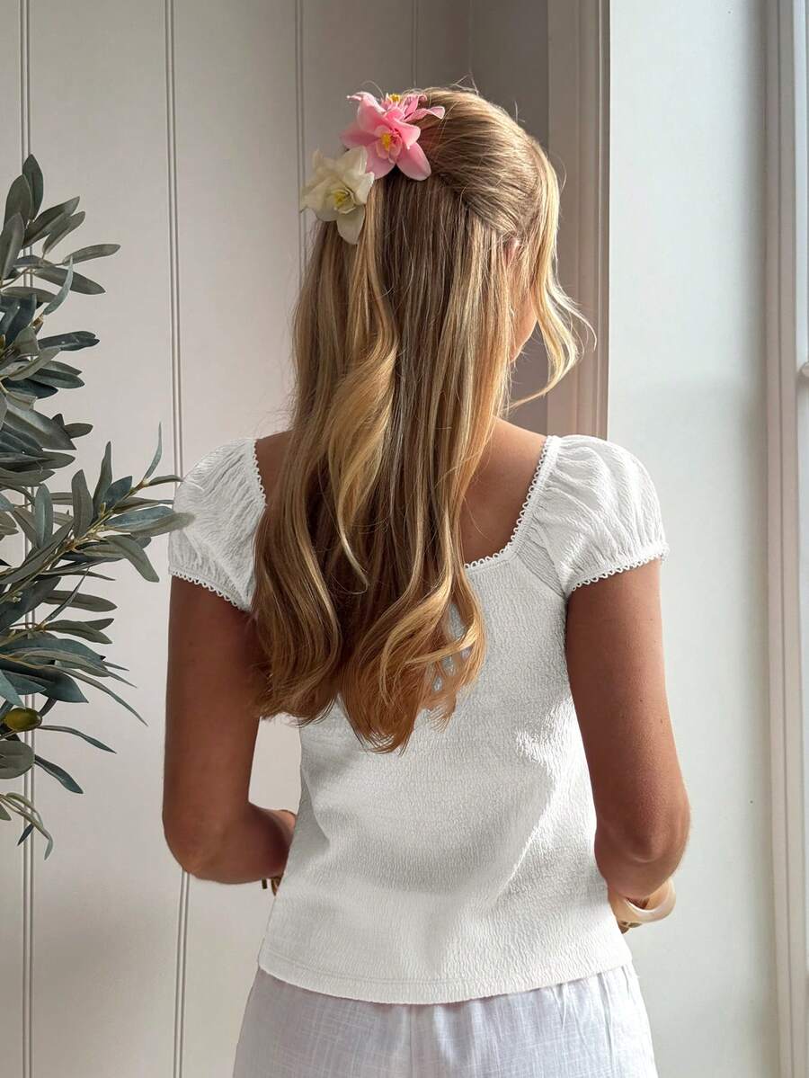White ditsy floral women's square neck short sleeve t-shirt featuring puff sleeves, frill details, and a slim fit flared hem.
