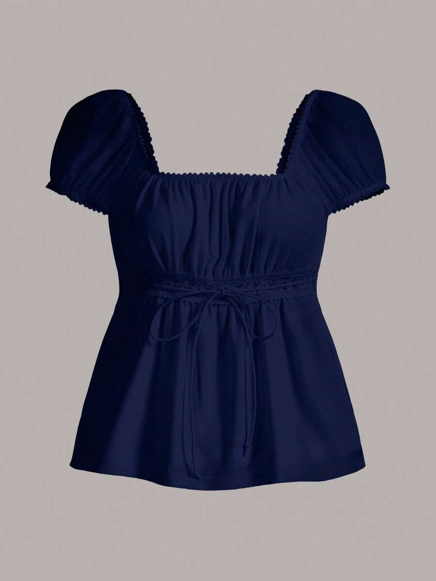 Women's black short puff sleeve top featuring a square neckline, ruched bust detail, and flared ruffle hem.