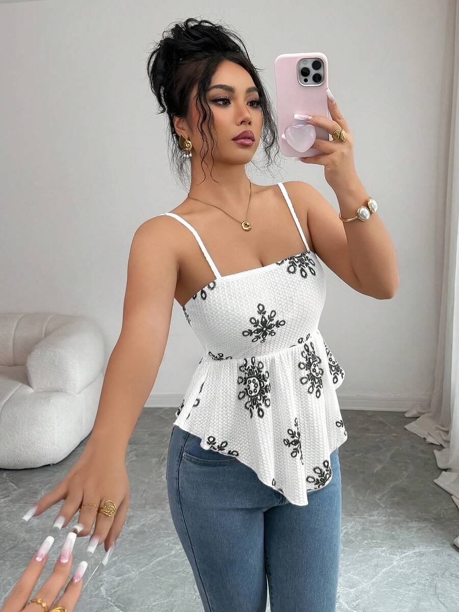 Women's floral snowflake print camisole top featuring spaghetti straps, slim fit, and an asymmetrical hem in navy blue knit fabric.