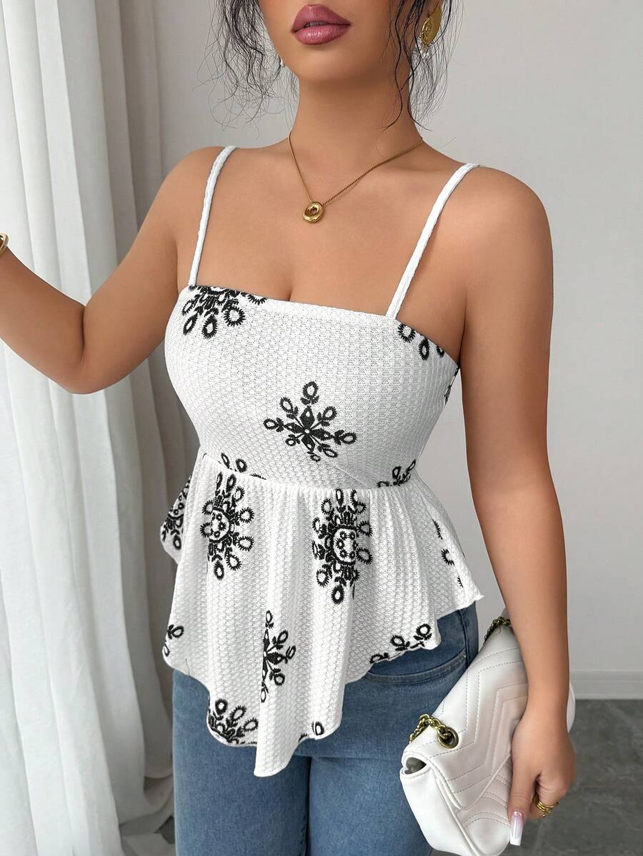 Women's floral snowflake print camisole top featuring spaghetti straps, slim fit, and an asymmetrical hem in navy blue knit fabric.