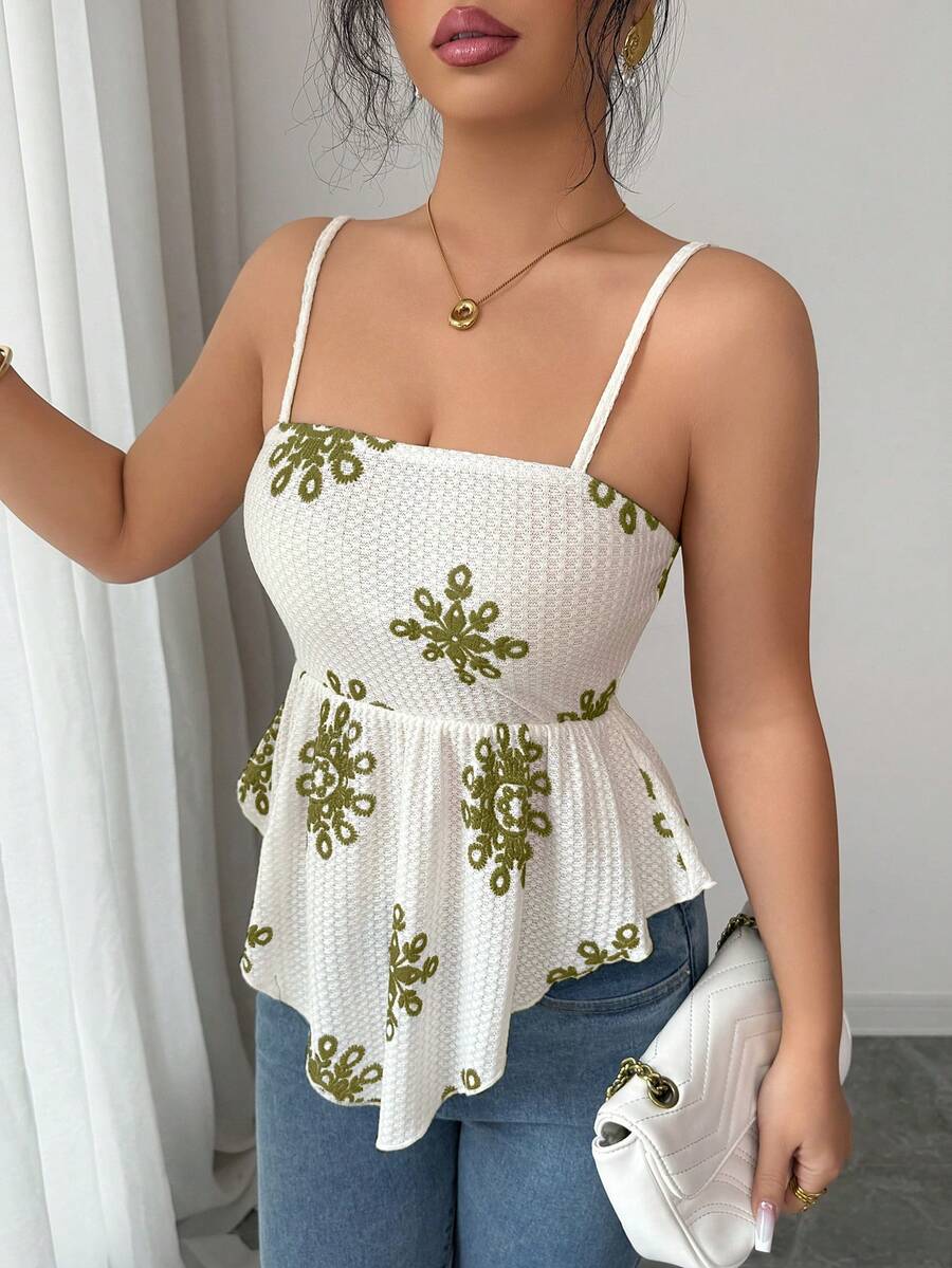 Women's floral snowflake print camisole top featuring spaghetti straps, slim fit, and an asymmetrical hem in navy blue knit fabric.