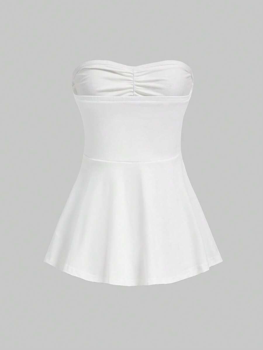 Women's striped strapless tube top featuring ruched detailing, flared hem, and stretchy knit fabric.