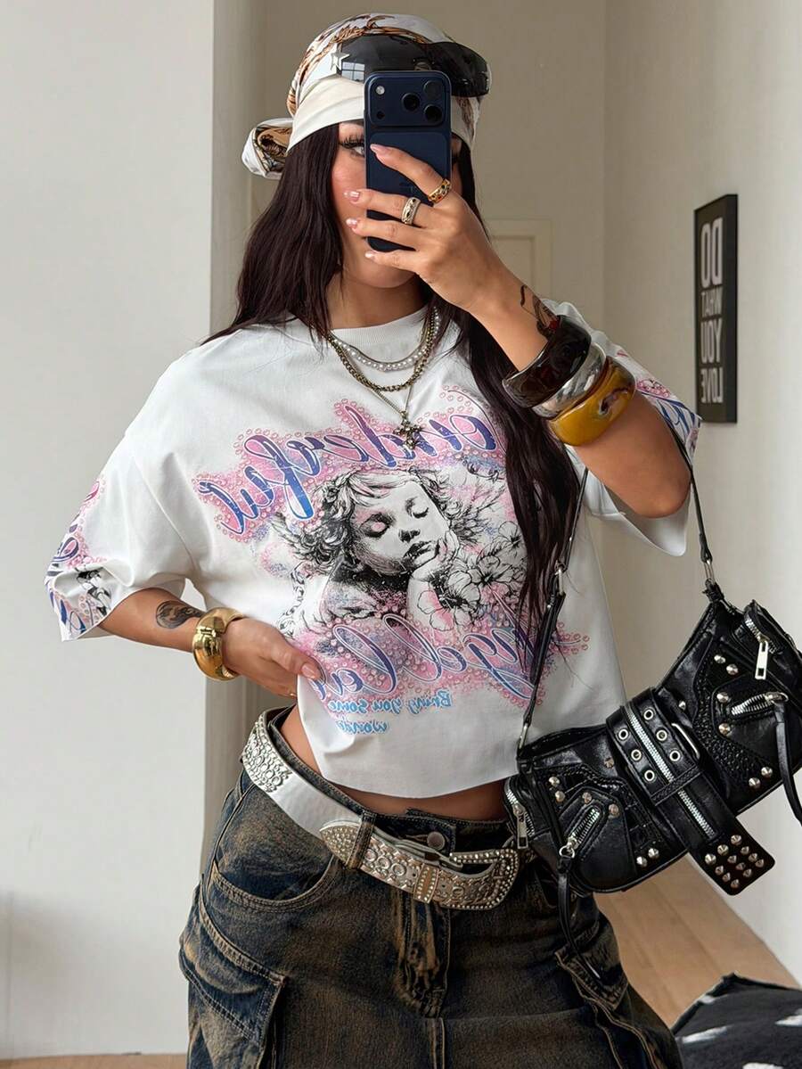 Front view of a women's black oversized crop t-shirt with pink lips graphic, round neckline, and short drop-shoulder sleeves.