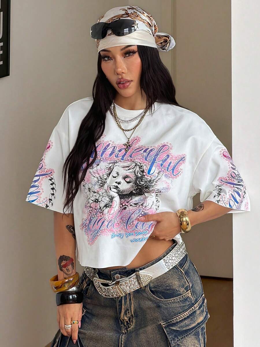 Front view of a women's black oversized crop t-shirt with pink lips graphic, round neckline, and short drop-shoulder sleeves.