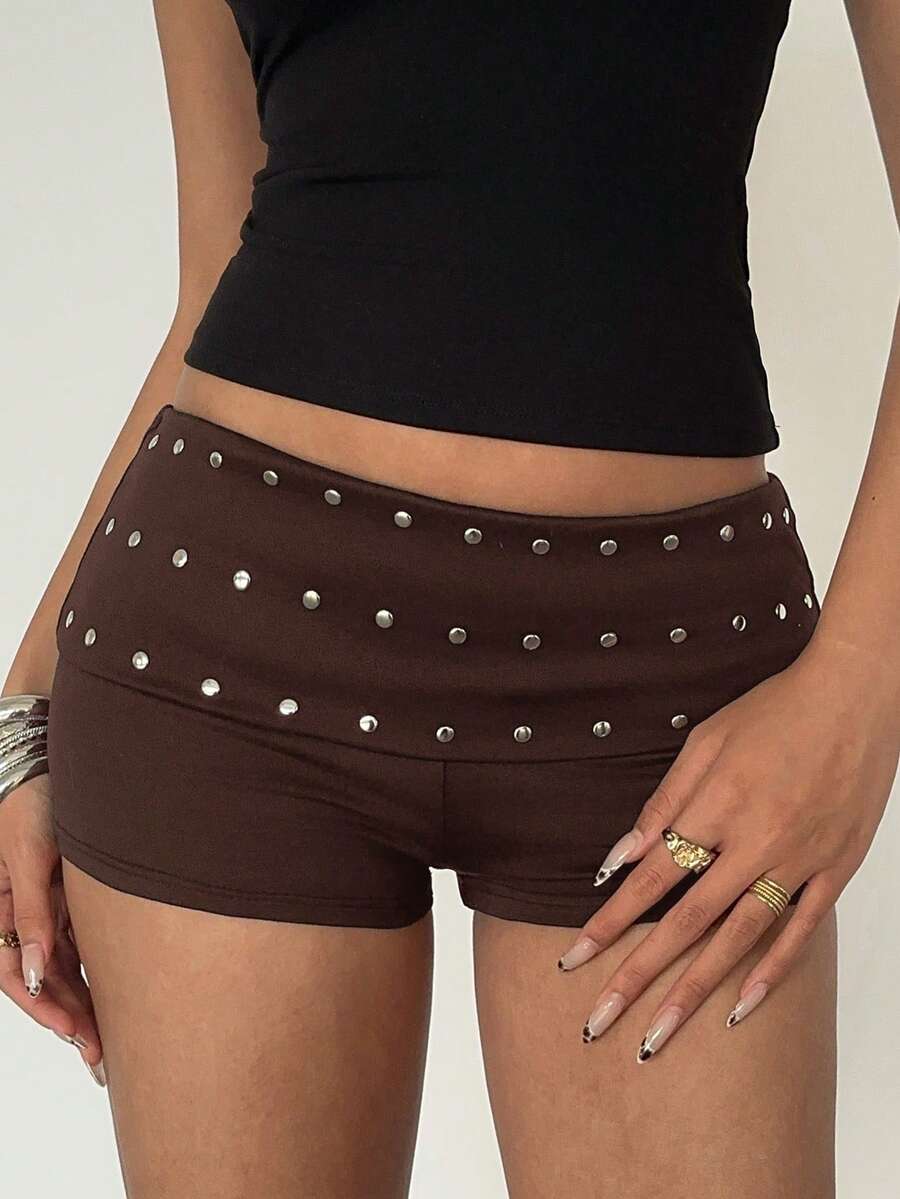 Women's studded PU ultra low waist mini shorts with zipper fly closure, skinny fit, mini length, and plain unlined design.