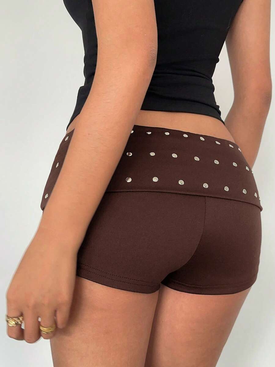Women's studded PU ultra low waist mini shorts with zipper fly closure, skinny fit, mini length, and plain unlined design.